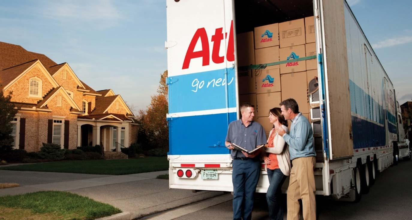 Spirit Movers Truck with family behind the bed