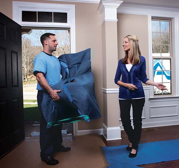 Man helping woman move furniture